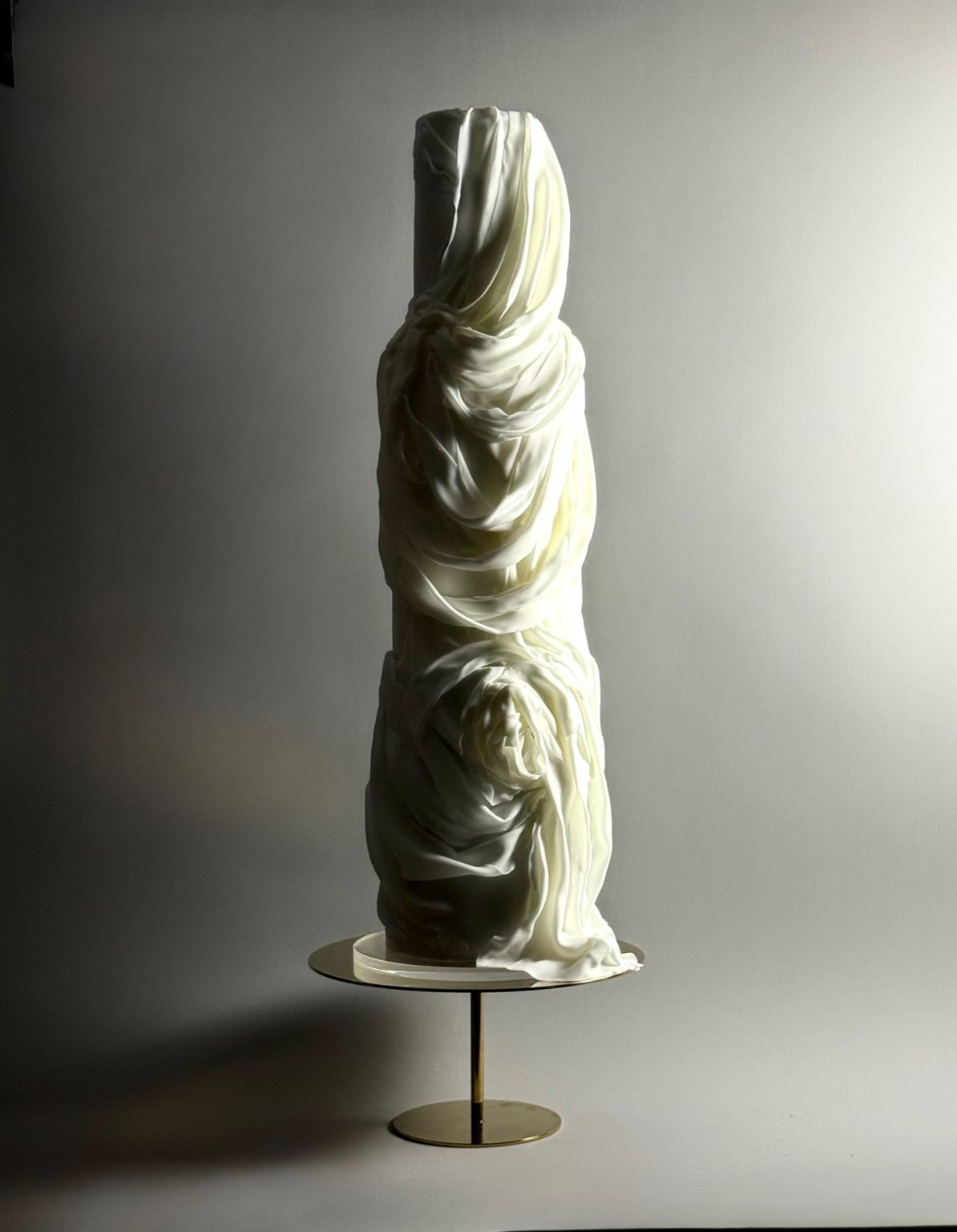 Tall ivory draped sculptural wedding cake
